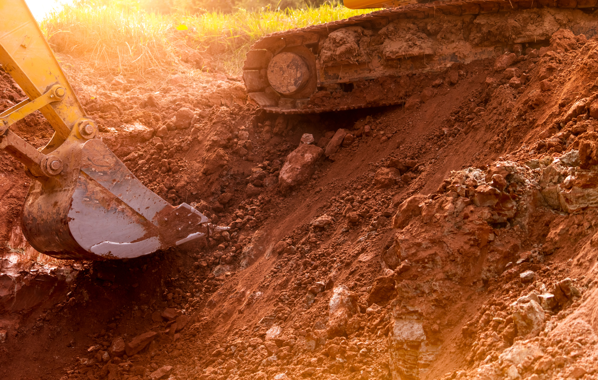 backhoe working by digging soil at construction site. bucket of